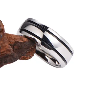 Polished tungsten steel ring for men with black parallel lines on a wood background