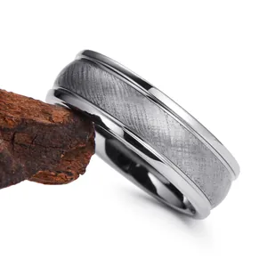 Silver brushed tungsten steel ring with polished edges on rustic wood display