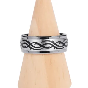 Detail of 8mm tungsten ring with black engraved wave pattern and brushed silver finish