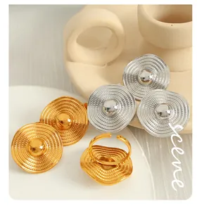 Detail of gold and silver rings with concentric relief texture and adjustable opening