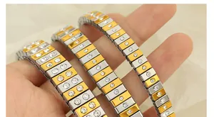 Detail of two-tone stretch bracelets featuring pavé rhinestones in polished gold and silver