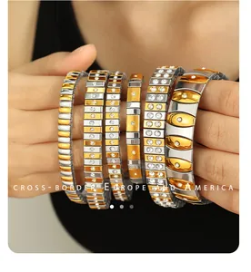 Detail of mixed-color elastic steel bracelets featuring inlaid cubic zirconia accents
