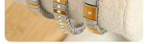 Detail of two-tone stainless steel stretch bracelet with crystal-inlaid metal links
