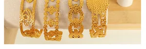 Detailed view of hammered 18K gold plated bangles with evil eye and clover patterns