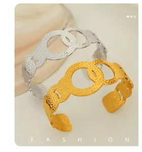 Detail of 18K gold and silver textured hollow bangles with intertwined design