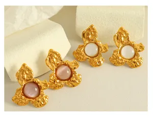 Macro view of French vintage floral studs with cat-eye stones and hammered metal finish