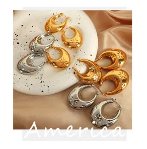 Detailed view of gold and silver crescent earrings with embossed floral patterns