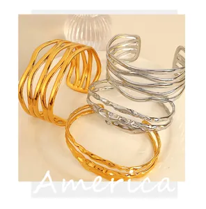 Set of gold and silver plated open cuff bracelets with wavy hollowed-out patterns