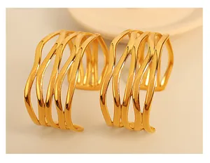 Close-up detail of luxury 18K gold-plated cuff bracelet featuring an elegant wavy hollow design