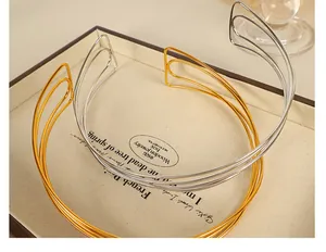 Detailed view of layered gold and silver choker necklaces on a premium jewelry display tray