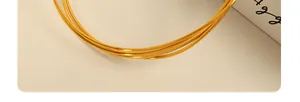 Detail view of a minimalist thin gold choker necklace showing a sleek metallic finish
