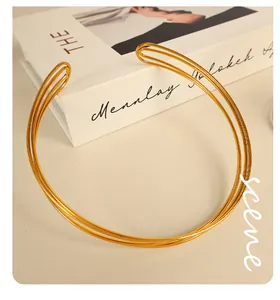 Detail of elegant gold multi-layered metal choker necklace with polished finish