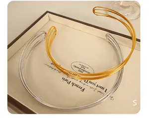 Detailed view of multilayer wire choker necklaces in gold and silver finish