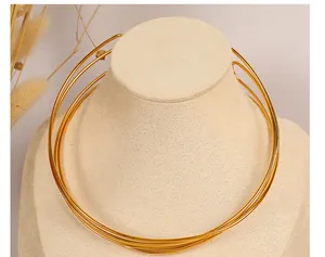 Detail of elegant gold multi-layer collar necklace on a mannequin with dried flower decor