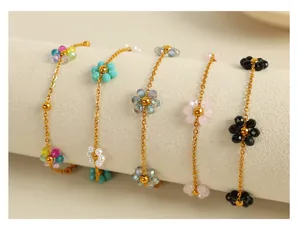 Detail of five colorful 18k gold plated titanium flower charm bracelets on display