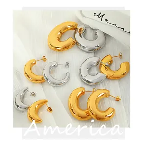 Detailed view of polished gold and silver C-shaped hoop earrings in various sizes