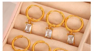 Detailed shot of 18K gold plated hoop earrings with rectangle clear zircon pendants
