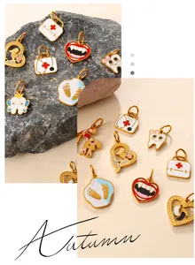 Detailed view of medical themed enamel charms including first aid kit and tooth designs