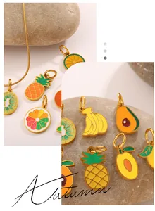 Detail of colorful fruit charms in pineapple and lemon shapes with gold enamel finish