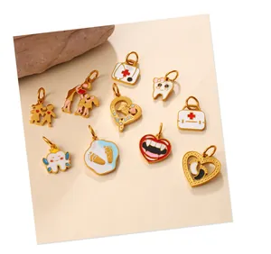 Detail view of gold-plated enamel medical pendants with first aid kit and tooth designs
