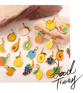 Macro view of assorted fruit pendants with colorful enamel on gold-tone metal bases