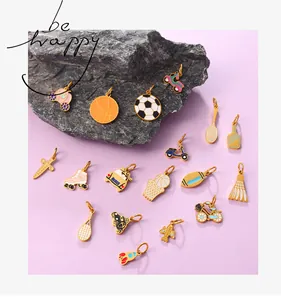 Macro detail of colorful enamel sports and transport charms with gold-plated finish