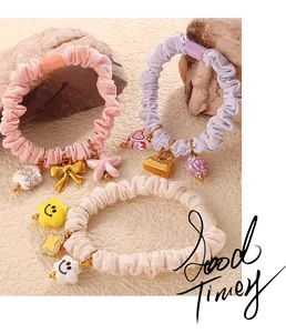 Detailed view of pink and pastel scrunchie set with bow and star charms on stones