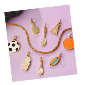 Detail of vibrant sports-themed golden pendants with football, basketball and tennis rackets