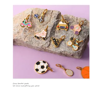 Macro detail of colorful enamel sports and transport charms on a natural rock surface