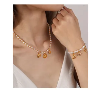 Close-up of celestial star and moon charms on a pearl necklace and bracelet set
