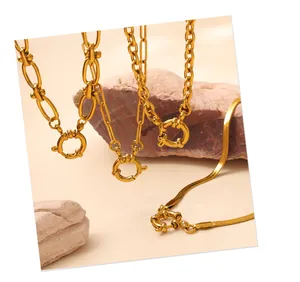 Detailed view of gold plated link chains with circular spring clasps and snake chain texture