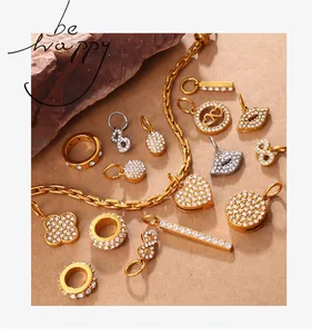Detailed view of sparkling gold and silver crystal charms with heart and ring motifs