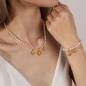Star and moon pendant necklace and bracelet set with pearls and rhinestones on a model