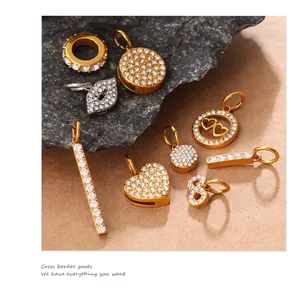 Close-up of gold and silver charms featuring hearts and circles with pavé set crystals