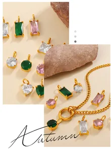Close-up of geometric zircon pendants in heart and rectangle shapes with gold chains
