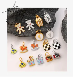 Detailed close-up of colorful enamel bear and castle charms on a premium stone background