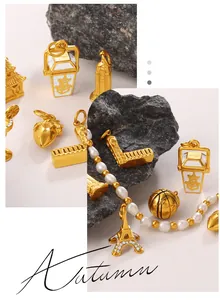 Macro detail of Eiffel Tower and cocktail pendants with pearls on dark stone surface