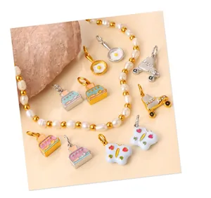 Detail of colorful enamel pendants featuring miniature fried egg and camera designs