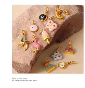 Detail of colorful enamel charms featuring windmill and ice cream on natural stone