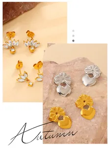 Detail of golden lotus stud earrings with marquise zircons and heart-shaped backings
