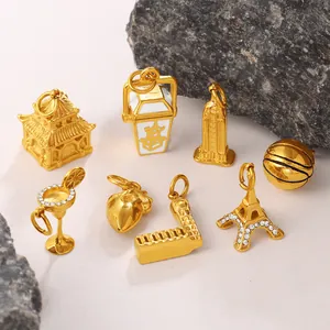 Gold pendant collection featuring Eiffel Tower, martini glass, and Chinese pagoda charms