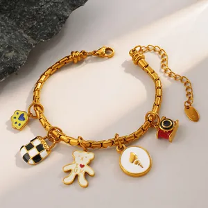 Golden stainless steel bamboo link bracelet with check bag and bear charms