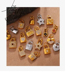 Macro view of gold and silver lock heart and star pendants with pavé zircons