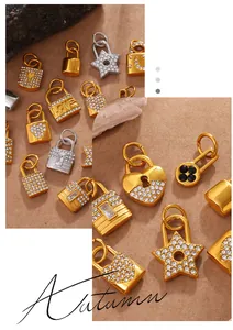 Macro detail of heart and star pendants with pavé zircons and gold-plated finish
