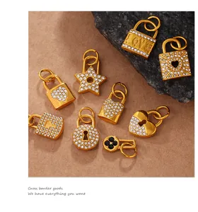 Macro view of gold plated lock and heart pendants with pavé crystals on a textured base
