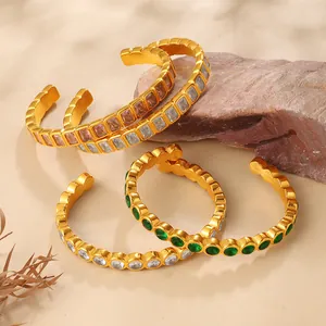 Gold-plated C-shaped cuff bracelets with colorful zircon stones in a natural setting