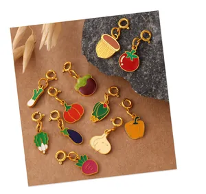 Macro detail of assorted enamel vegetable charms with gold lobster clasps for DIY jewelry