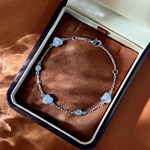 Détail macro du bracelet cœur en argent avec zircon, fermoir et étiquette pureté