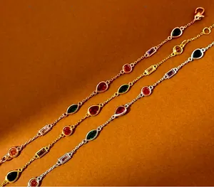 Detailed macro of crystal chain bracelets in rose gold, gold, and silver metal finishes