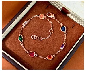 Detail of rose gold bracelet with multi-color teardrop and marquise gems in jewelry box